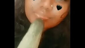 some gross indian female gargling a cucumber